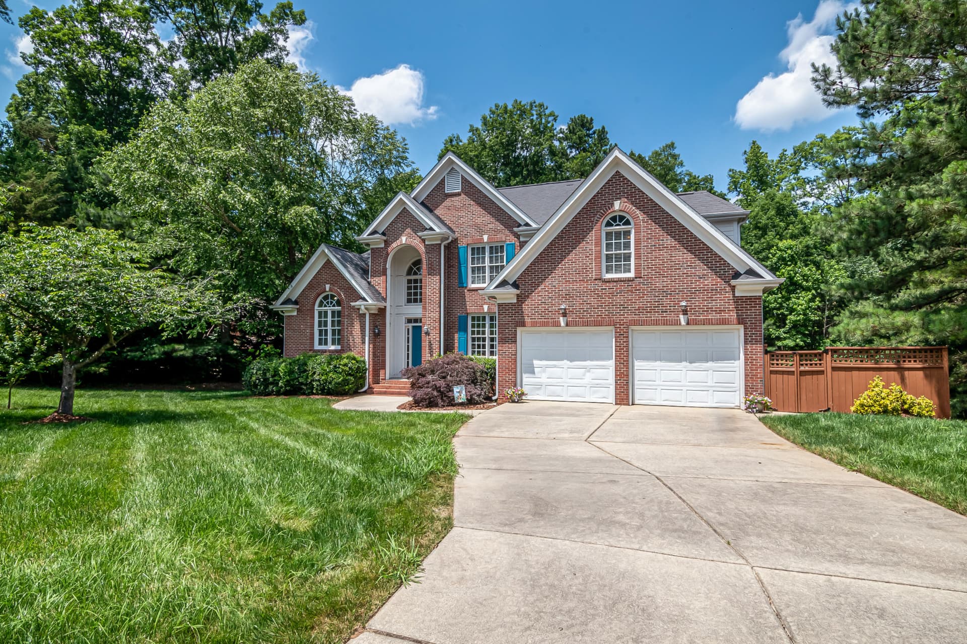 Brick home with a green lawn and tidy driveway in a Cleveland west side neighborhood