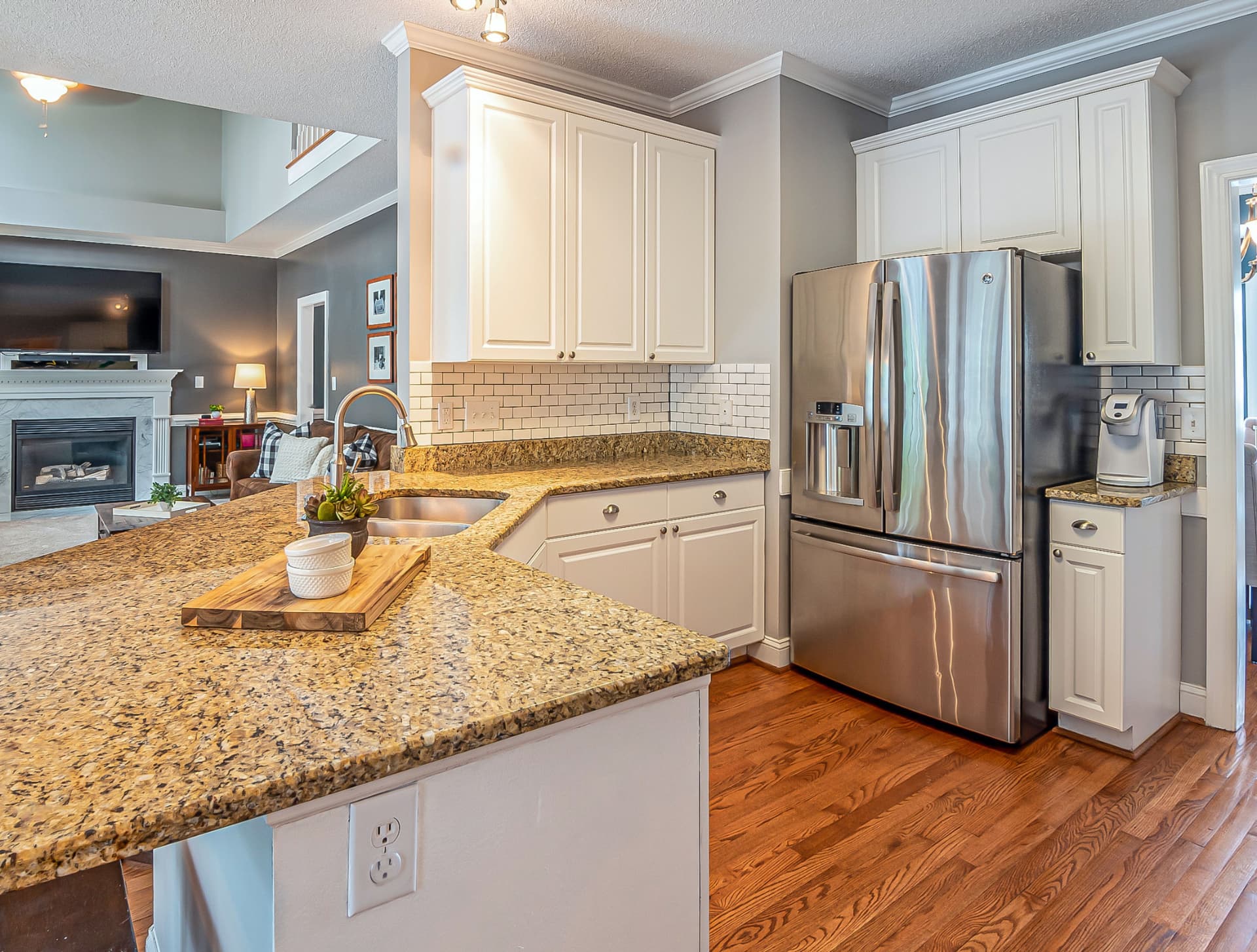 Clean kitchen with white cabinets, granite counters, and stainless steel appliances in a Cleveland west side home